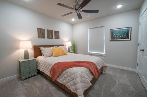 a bedroom with a bed and a ceiling fan at Back 40 Homestead - Trailside Basecamp in Bella Vista