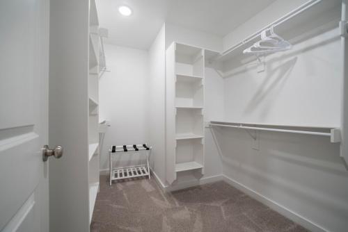 a white walk in closet with white shelves at Back 40 Homestead - Trailside Basecamp in Bella Vista