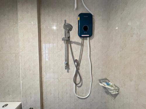 a shower in a bathroom with a shower head at Royal BJ Hotel in Pattaya South