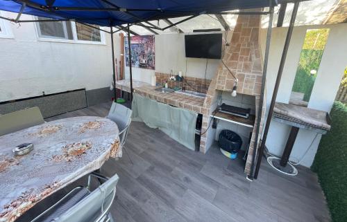 a room with a table and a tv in a trailer at къща за гости ЕЛИАНИ in Gabrovo