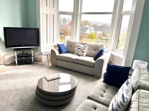 a living room with a couch and a tv at Home in Dunoon Argyll and Bute in Dunoon