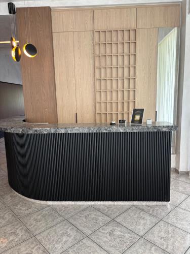 a lobby with a counter with a laptop on it at Therma Hotel in Loutra Ipatis