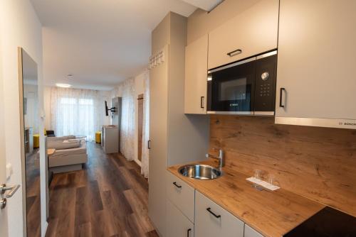 a kitchen with a sink and a counter top at Hotel Restaurant Fallerhof in Bad Krozingen