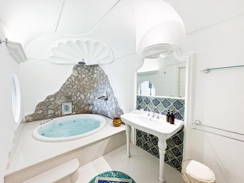 a bathroom with a tub and a sink at Amira Capri in Anacapri
