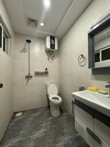 a bathroom with a toilet and a sink at Stayease in Lahore