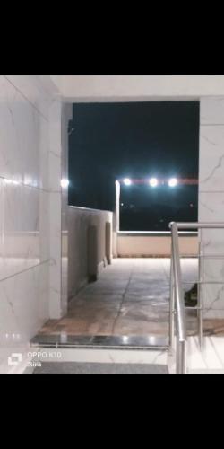an empty room with a view of the ocean at night at Sg hotel in Bhopal