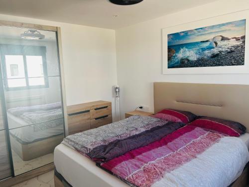 a bedroom with a bed and a glass wall at Ferienhaus direkt am Strand mit Terrasse und Meerblick in Torrevieja in Punta Prima