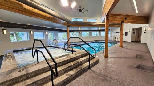 a large swimming pool with stairs in a building at CC102 Buffalo Village in Silverthorne