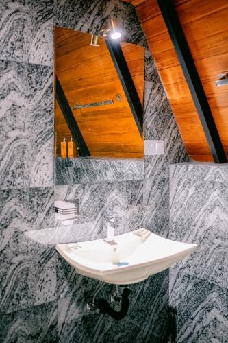 a bathroom with a sink and a mirror at Brilliant View Cottages in Ella