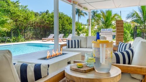 a patio with a swimming pool and a table with candles at Tranquility Villa Heated Pool & Lanai in Jupiter