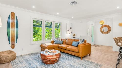 a living room with a couch and a table at Tranquility Villa Heated Pool & Lanai in Jupiter
