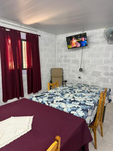 a bedroom with a bed and a tv on the wall at Aurora in Santiago del Estero