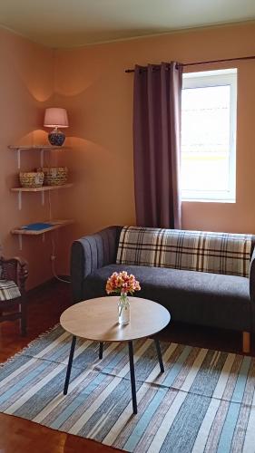 a living room with a couch and a table at Faial Cottage in Cedros
