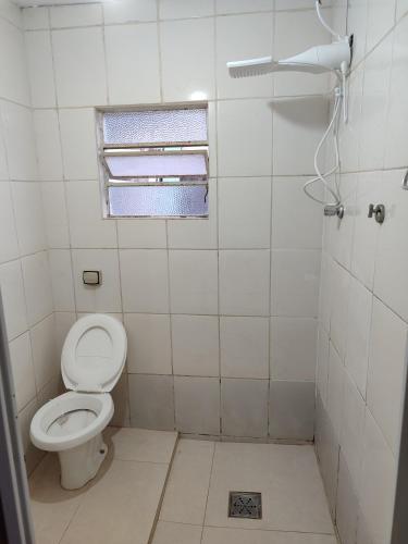 a small bathroom with a toilet and a window at Kitnet 03 Lunardi Campinas in Campinas