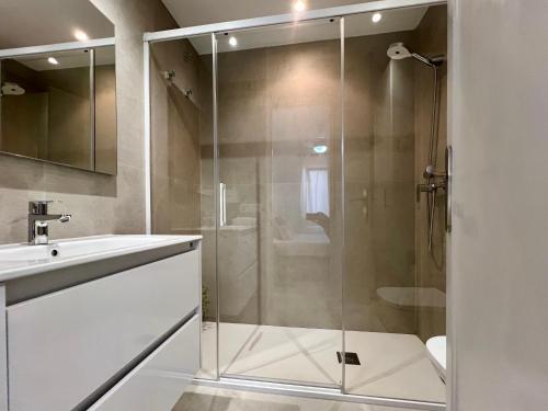 a glass shower in a bathroom with a sink at Disfruta del Paraiso in Son Parc