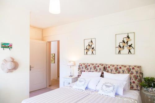 a bedroom with a bed with white sheets and pillows at Ktima Aniforeli Luxury Villas in Sivota
