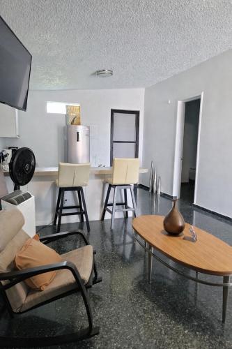 a living room with a couch and a table at Dorado Costa De Oro Beach 2 Bedroom Oceanfront by Rentalspr in Dorado