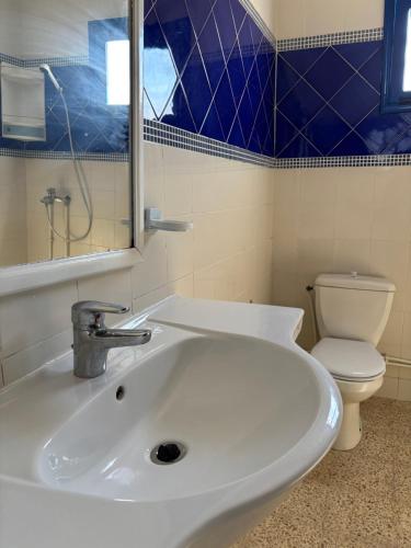 a bathroom with a white sink and a toilet at Jardins de Mezraya in Mezraya