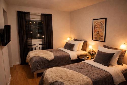 a hotel room with two beds and a window at City Living Trelleborg in Trelleborg