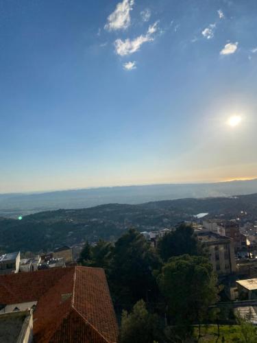 a view of a city with the sun in the sky at Kruja Apartment SA in Krujë