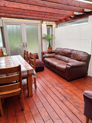 a living room with a couch and a table at Tom's Alpaca Cottage in Mooncoin