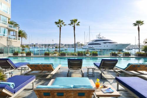 a cruise ship in the water with chairs and a pool at Venice Marina Water Front Luxury Condo in Los Angeles