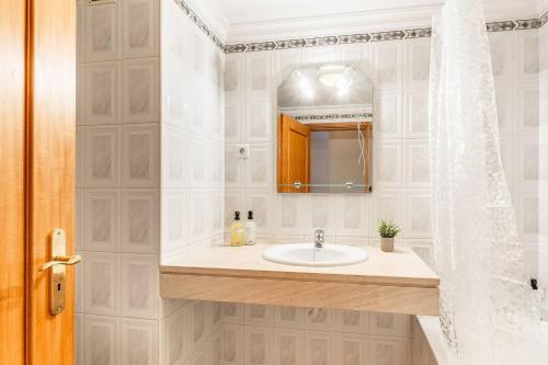 a bathroom with a sink and a mirror at Sardonyx Scape Madeira Close to Garajau Funchal in Caniço