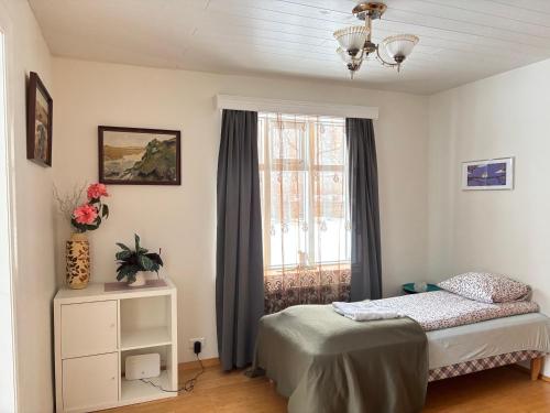 a bedroom with a bed and a window at Spacious Apartment -Top Location in Akureyri