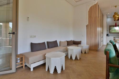 a living room with a couch and two tables at Dar Sofia Villa in Marrakesh