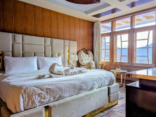 a bedroom with a large bed with a large headboard at The Jade Palace, Hunza in Karimabad Hunza
