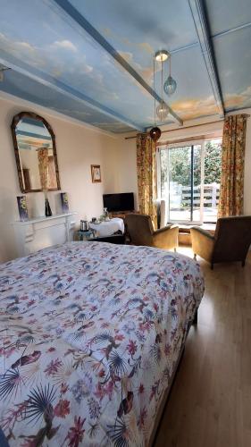 a bedroom with a large bed in a room at Chez Laurence in Locronan