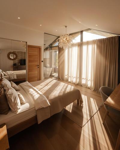 a bedroom with a large bed and a large window at Zen Resort & SPA in Purcari