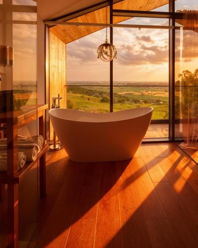 a bath tub in a room with a large window at Zen Resort & SPA in Purcari
