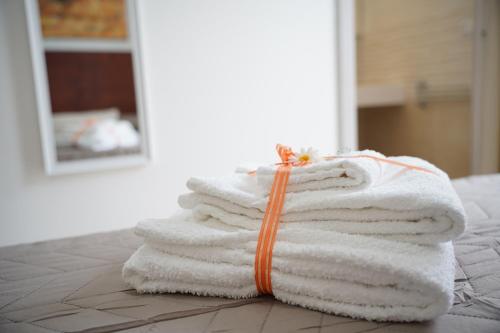 a stack of towels sitting on top of a table at Giocca Rooms in Palagiano