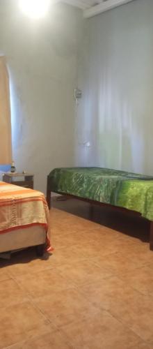 a room with two beds and a phone on the wall at tómate un descanso in Salto