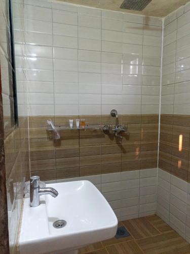 a bathroom with a sink and a shower at Jungle Nirvana Retreat in Meghauli
