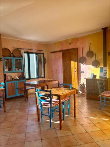 a dining room with a wooden table and chairs at Locanda D'Ogliastra in Triei