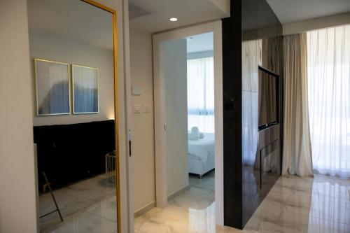 a room with a glass door leading to a bedroom at Liz suite in Caesarea