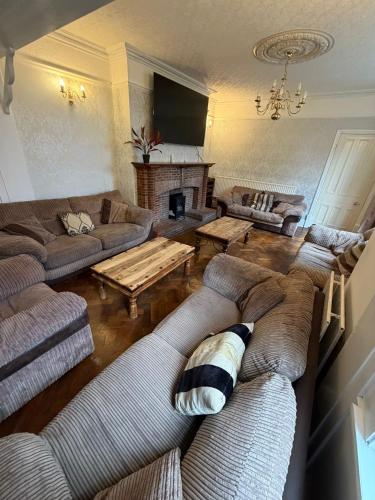 a large living room with couches and a fireplace at Spectacular Period Property Located In Leicester in Leicester