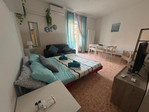 a bedroom with a bed and a living room at Lo Scorcio sul porto in Porto Santo Stefano