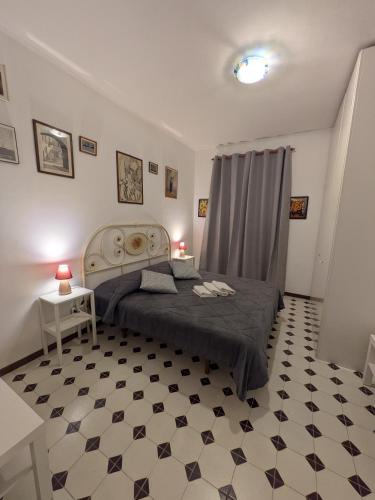 a bedroom with a bed and a black and white floor at Sunset House in Santa Marinella
