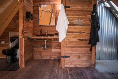 a bathroom with a sink and a wooden wall at Bodhi Farms in Bozeman