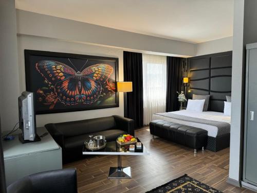 a hotel room with a bed and a butterfly painting at City One Hotel in Kayseri