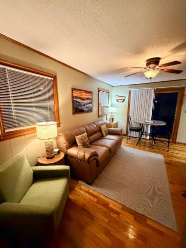 a living room with a couch and a table at Cozy Creek Cottages in Maggie Valley