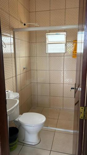 a bathroom with a toilet and a sink at Hotel R Soares 2 in Carutapera