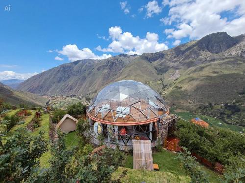 a glass dome on top of a building on a mountain at Stardome Spiritual Experience in Ollantaytambo
