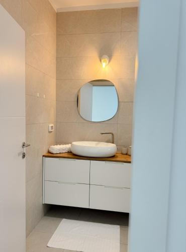 a bathroom with a sink and a mirror at וילת Velizabeth in Omen