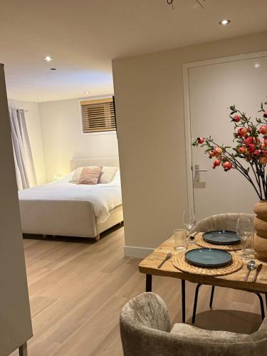 a bedroom with a bed and a table with plates on it at Duijnparadijs appartement 2 in Schoorl