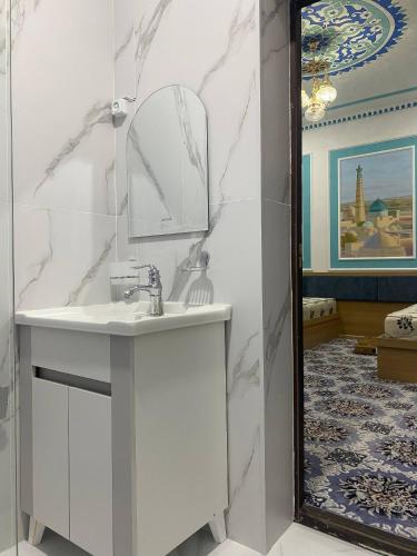 a bathroom with a sink and a mirror at Gavhar Boutique Hotel in Khiva