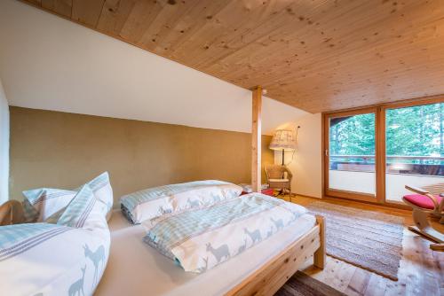 1 dormitorio con 2 camas y ventana grande en Waldhütte, en Hochpillberg